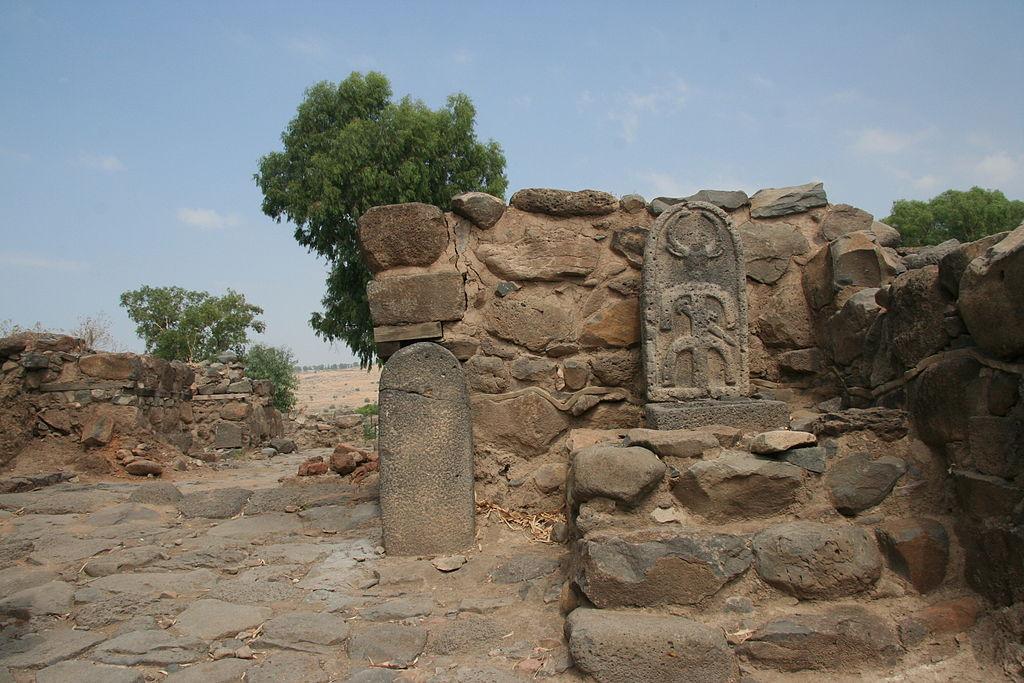 A stone wall with a stone carving

Description automatically generated