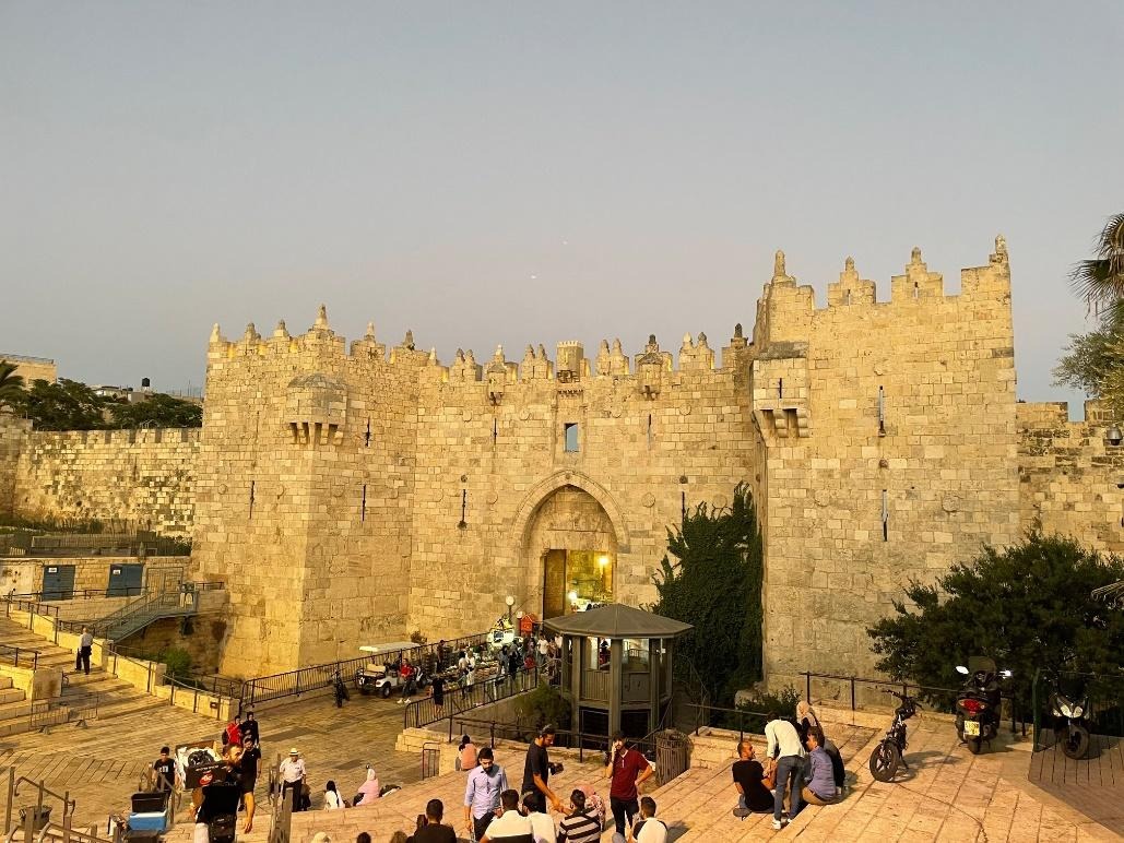 A stone castle with people walking around
AI-generated content may be incorrect.