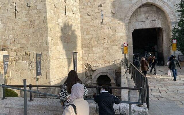 People standing in front of a stone building
AI-generated content may be incorrect.