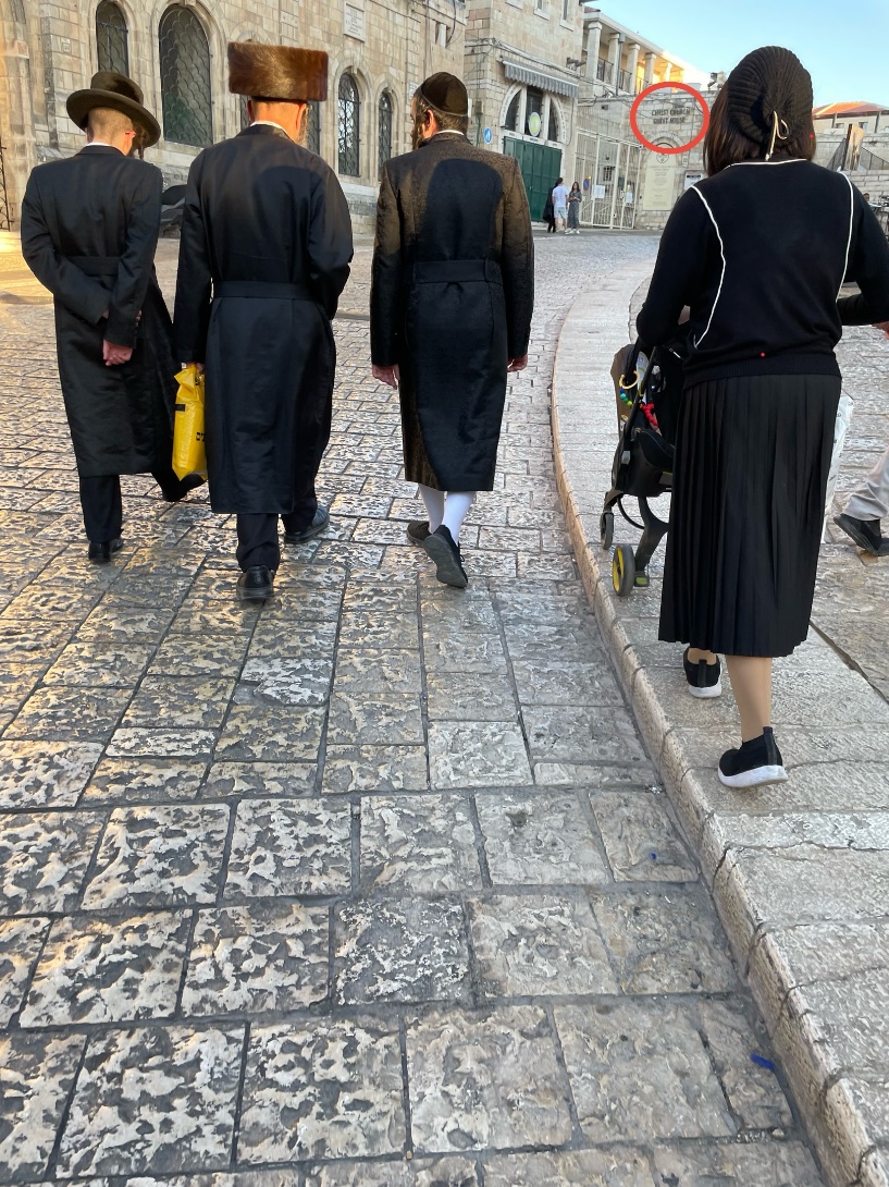 A group of people walking on a stone sidewalk
AI-generated content may be incorrect.